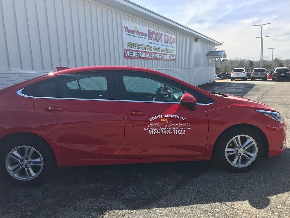 Red Team Hodges car parked outside auto body shop
