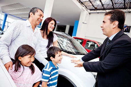 Salesman assisting a happy Famliy